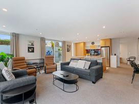 A living room with a sofa and armchairs at Waimahana 5 - Taupo Holiday Apartment in Waipahihi
