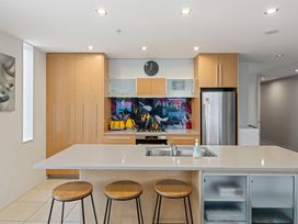 A kitchen with a stove and sink at Waimahana 5 - Taupo Holiday Apartment in Waipahihi