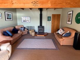 A living room with sofas and a wood stove at Moetapu Bay Bliss - Marlborough Sounds Retreat Moetapu Bay