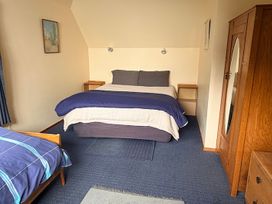 A bedroom with a bed and nightstand at Moetapu Bay Bliss - Marlborough Sounds Retreat in Moetapu Bay