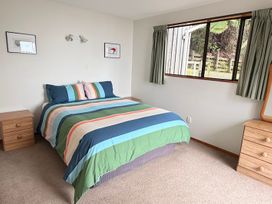 A bedroom with a bed and nightstands at Moetapu Bay Bliss - Marlborough Sounds Retreat in Moetapu Bay