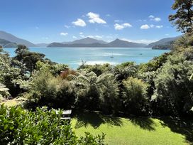 A view of the water and mountains from the garden at Moetapu Bay Bliss - Marlborough Sounds Retreat in Moetapu Bay