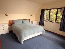 A bedroom with a bed and nightstand at Moetapu Bay Bliss - Marlborough Sounds Retreat in Moetapu Bay