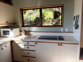 A kitchen with a microwave and kettle at Moetapu Bay Bliss - Marlborough Sounds Retreat Moetapu Bay