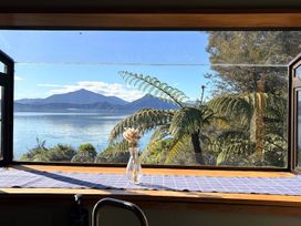 A view from a window featuring mountains and water at Moetapu Bay Bliss - Marlborough Sounds Retreat in Moetapu Bay