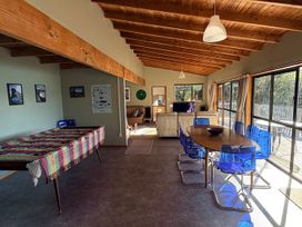 A living room with a table and chairs at Moetapu Bay Bliss - Marlborough Sounds Retreat, Moetapu Bay