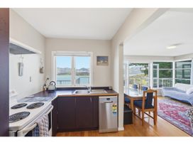 A kitchen with a stove and sink at Bayview Beauty - Charteris Bay