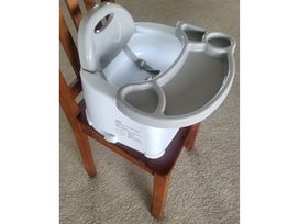 A booster seat on a wooden chair at Heart of Waipu - Waipu