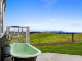 An outdoor area with a green bathtub and a window at Heart of Waipu - Waipu