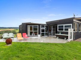 An outdoor area with chairs and a bathtub at Heart of Waipu - Waipu