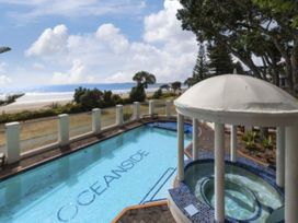 A poolside view of the sea at Poolside Waterfront - Orewa Oceanside Villa in Orewa