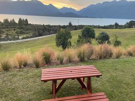 A picnic table with view of the lake and mountains at Southland Sanctuary - Te Anau Holiday Home Fiordland