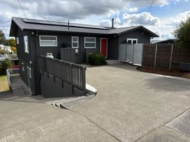 A house with a driveway and solar panels at Willow Lake House - Lake Taupo Holiday Home Rainbow Point