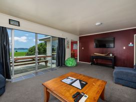 A living room with a coffee table and sofa at Te Tiriti Beach House - Paihia