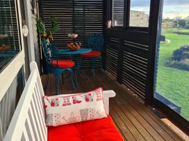 A patio with a table and chairs at Onaeros Cute Little Cottages - Taranaki Retreat, Waitara