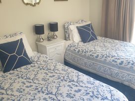 A bedroom with two single beds and a nightstand at Sunny Daze - Ohope Beach Holiday Home Ohope Beach