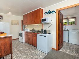 A kitchen with appliances and cabinetry at Dream View Waterfront - Paihia Holiday Home in Paihia