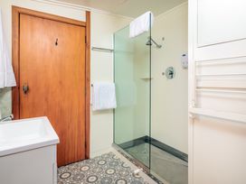 A bathroom with a shower and sink at Dream View Waterfront - Paihia Holiday Home, Paihia