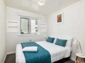 A bedroom with a bed and lamp at Dream View Waterfront - Paihia Holiday Home, Paihia