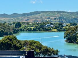 A landscape with water and trees at Sunset Stay - Raglan Holiday Home in Raglan