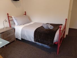 A bedroom with a bed and bedside table at Glass Horizon - Rutherglen Holiday Home Rutherglen