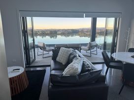 A living room with a view and furniture at Estuary Views - Riverhead Holiday House in Riverhead