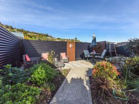 A garden with a table and chairs at Tahunanui Shoreside - Nelson Holiday Home Tahunanui Beach