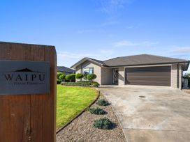 A single story house with garage and landscaped front yard at Waipu Green Estate in Waipu