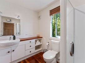 A bathroom with a sink cabinet toilet window and shower at Peaceful Outlook - Hatepe Holiday Home in Hatepe