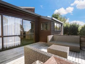 An outdoor area with furniture at Waiake Family Retreat - Auckland Holiday Home