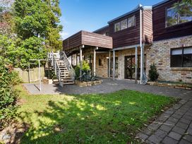 An outdoor area with a staircase and garden at Waiake Family Retreat - Auckland