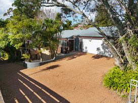 A driveway leading to a garage at Waiake Family Retreat - Auckland