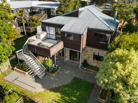 A house with a deck and stairs at Waiake Family Retreat - Auckland
