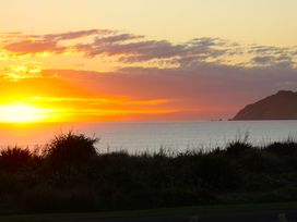 A sunset over the sea at Sunset Haven - Mahia Holiday Home Mahia Peninsula