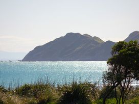 A view of the ocean and mountains at Sunset Haven - Mahia Holiday Home Mahia Peninsula