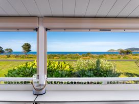 An outdoor view showing ocean and greenery at Sunset Haven - Mahia Holiday Home, Mahia Peninsula