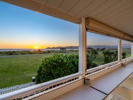 A view of the sea and sunset from an outdoor area at Sunset Haven - Mahia Holiday Home in Mahia Peninsula