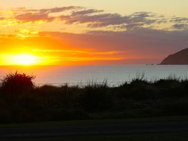 A sunset over the ocean at Mahia Bliss - Surf & Serenity Holiday Home, Mahia Peninsula