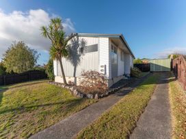 A house with a garden and pathway at The Bay Breeze Retreat - Two Mile Bay