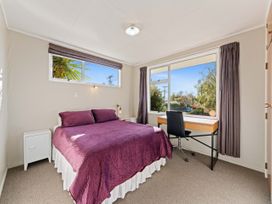 A bedroom with a bed and desk at The Bay Breeze Retreat - Two Mile Bay