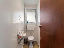 A bathroom with a toilet and sink at The Bay Breeze Retreat - Two Mile Bay