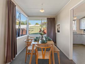 A dining room with a table and chairs at The Bay Breeze Retreat - Two Mile Bay