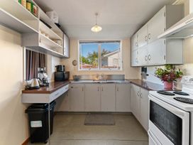 A kitchen with cabinets and appliances at The Bay Breeze Retreat - Two Mile Bay