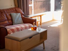 A living room with a sofa and a coffee table at The Bay Breeze Retreat - Two Mile Bay