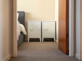 A bedroom with a bed and two nightstands at The Bay Breeze Retreat - Two Mile Bay