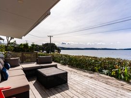 An outdoor area with a sofa and coffee table at Heron's Hideaway - Snells Beach