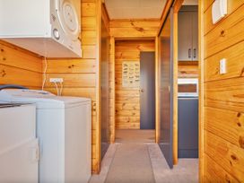 A laundry room with a washing machine and dryer at Seabreeze Surf House - Whitianga