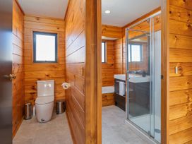 A bathroom with a toilet and shower at Seabreeze Surf House - Whitianga