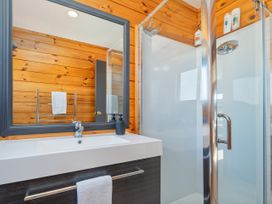 A bathroom featuring a sink and shower at Seabreeze Surf House - Whitianga Escape