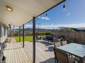 An outdoor area with a deck and seating at Seabreeze Surf House - Whitianga